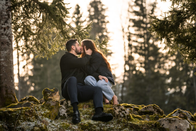 Photographe mariage couple Morez Jura Genève Lausanne Champagnole Lons-le-Saunier Besançon – couple enlacé sur un rocher sous les sapins
