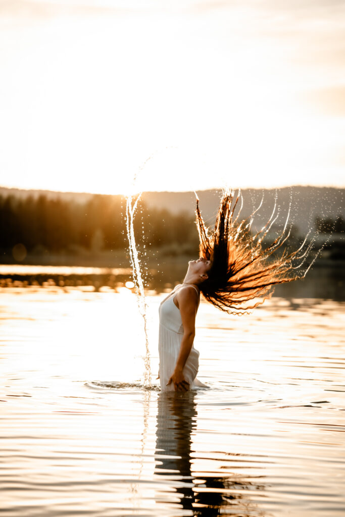 Photographe portrait Morez Jura Genève Lausanne Champagnole Lons-le-Saunier – femme projetant ses cheveux mouillés dans un lac