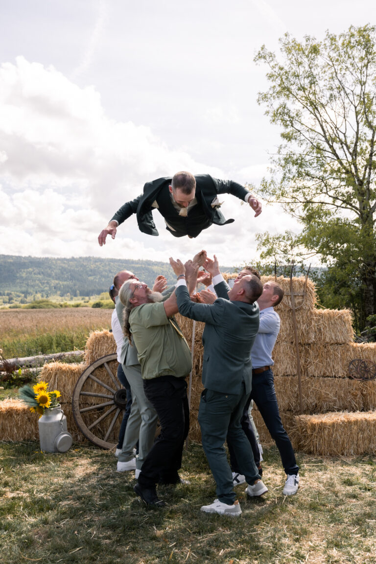 Photographe mariage Jura : marié lancé en l’air par ses amis