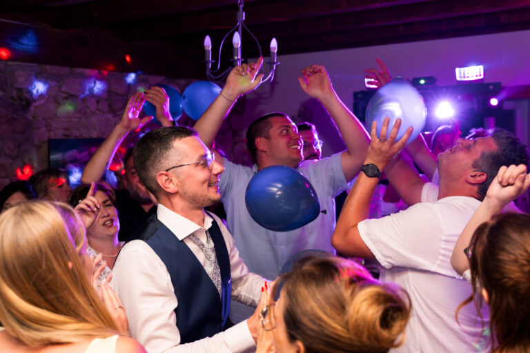 Photographe mariage Jura : invités qui sautent avec des ballons sur la piste