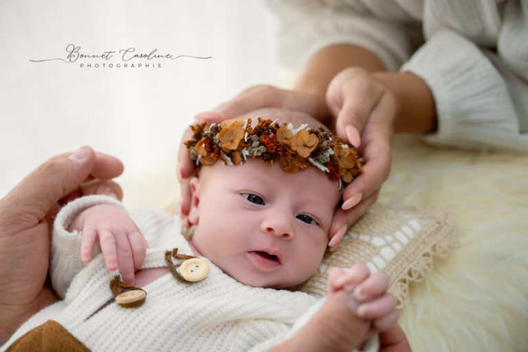 Photographe naissance Jura Morez – bébé éveillé avec couronne de fleurs